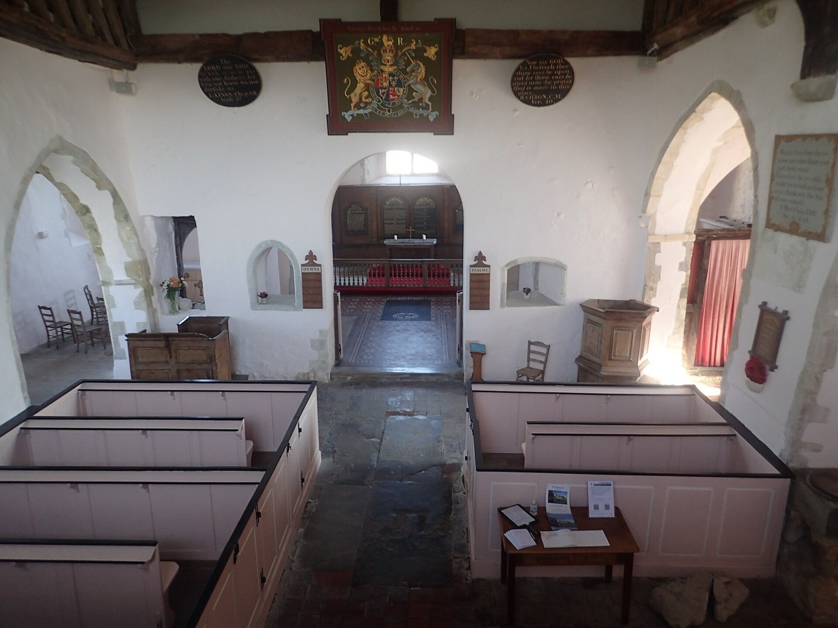 The pink box pews inside St Clement's Church, Old Romney